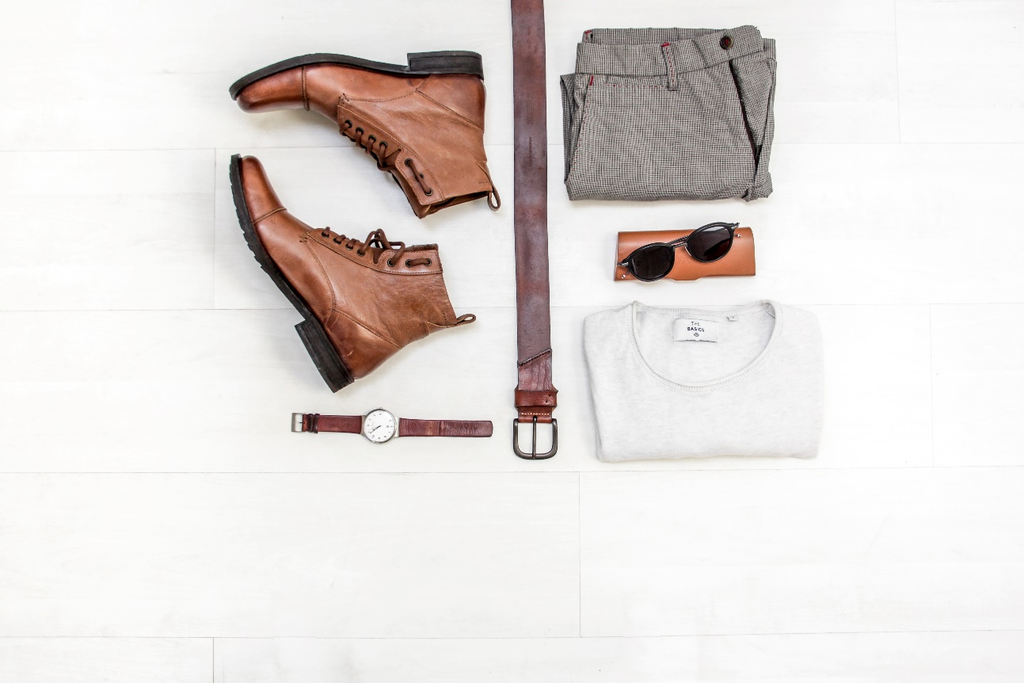 A pair of shoes, leather belt, trousers, and other men's accessories. 