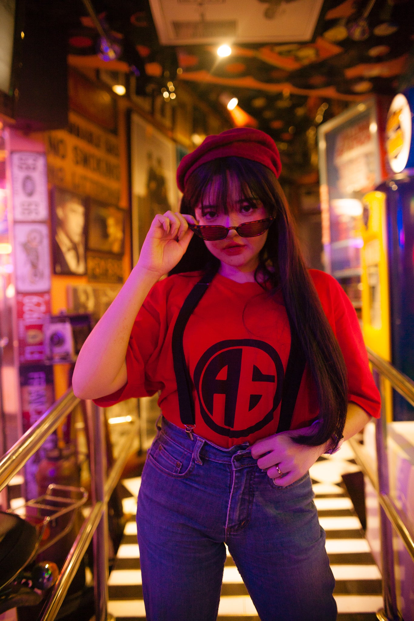 Woman wearing red t-shirt and suspenders